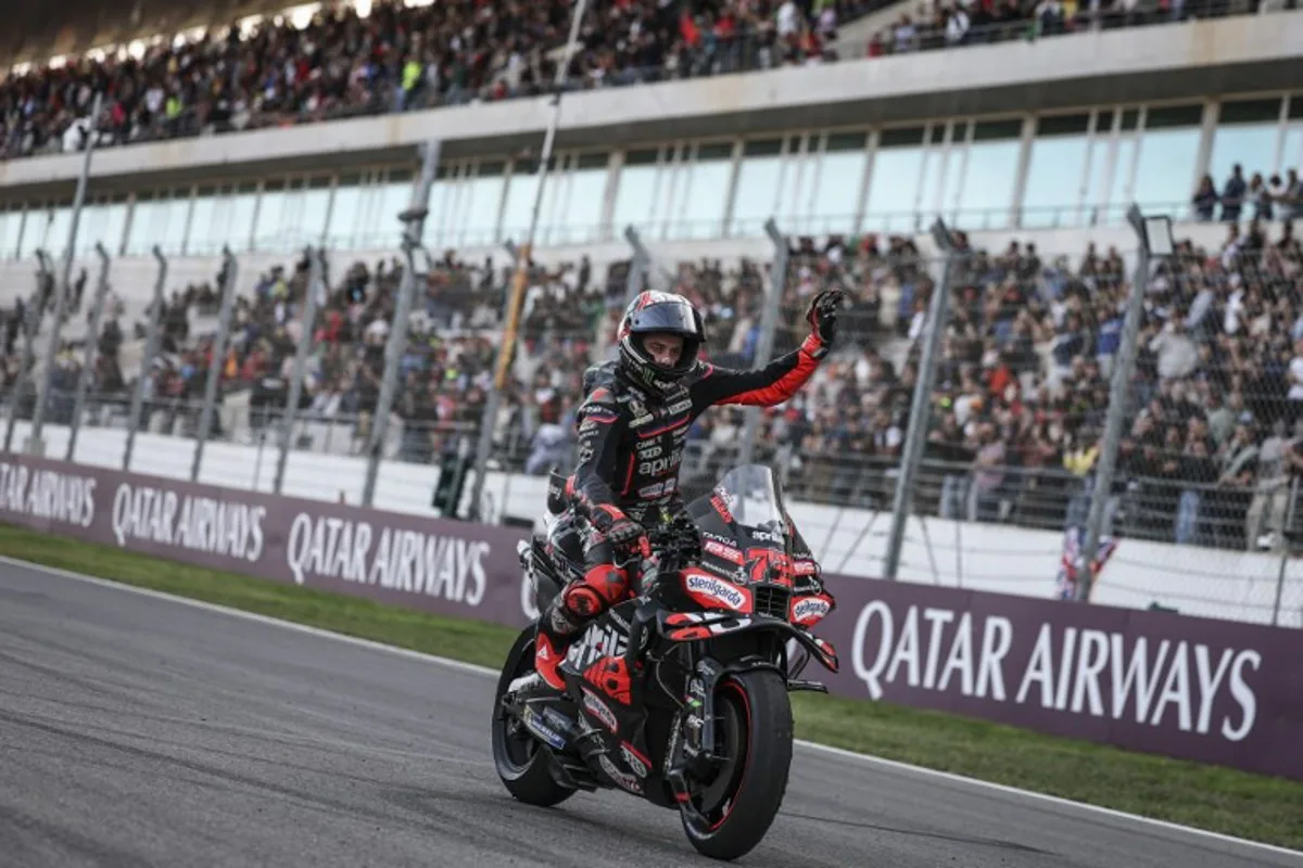 Aprilia Racing team's Italian MotoGP rider Marco Bezzecchi celebrates his third place in the MotoGP sprint race of the Portuguese Grand Prix at the Algarve International Circuit in Portimao on November 8, 2025. PATRICIA DE MELO MOREIRA / AFP