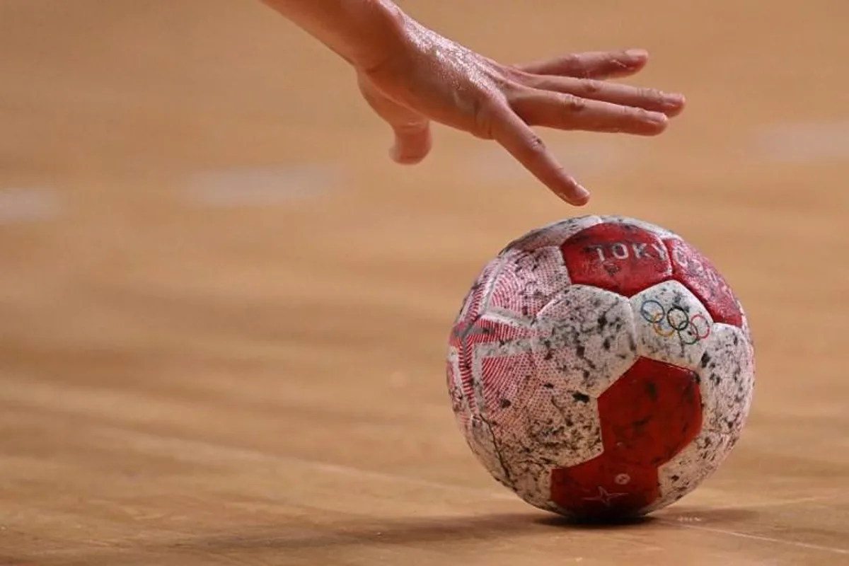 A handball player grabs the ball during the women's preliminary round group B handball match between Sweden and France of the Tokyo 2020 Olympic Games at the Yoyogi National Stadium in Tokyo on July 29, 2021.  Martin BERNETTI / AFP