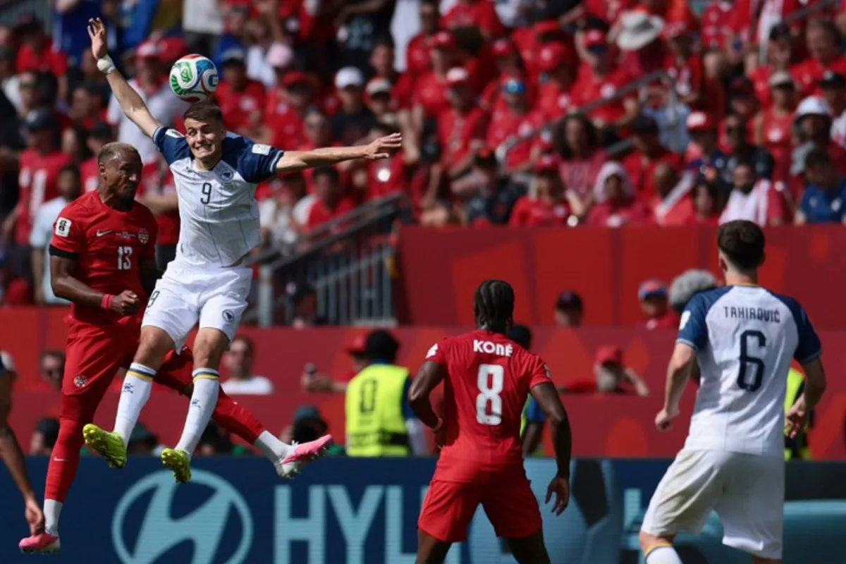 Canada's defender #13 Derek Cornelius (L) fights for the ball with Bosnia-Herzegovina's forward #09 Samed Bazdar (2ndL) during the 2026 World Cup Group B football match between Canada and Bosnia and Herzegovina at the Toronto Stadium in Toronto on June 12, 2026. Cole Burston / AFP