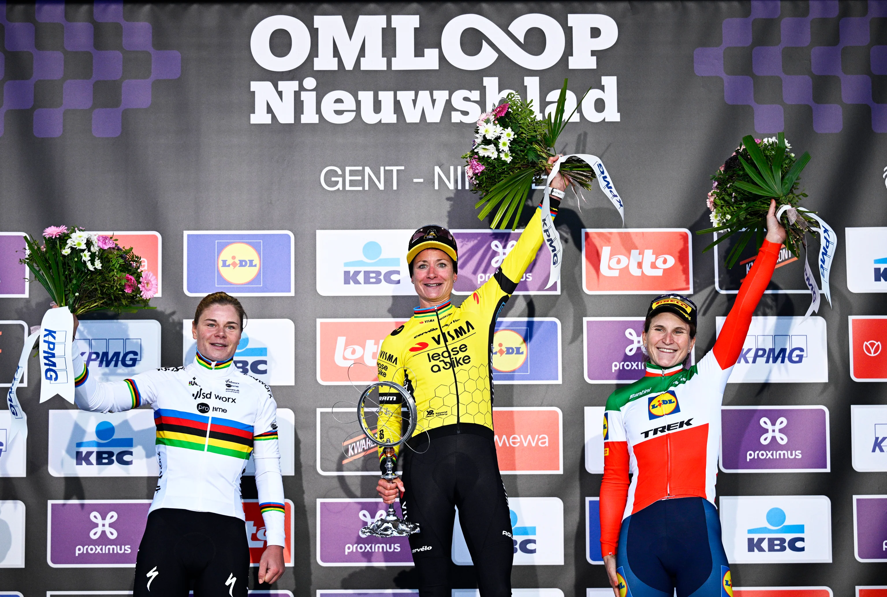 Belgian Lotte Kopecky of SD Worx - Protime, Dutch Marianne Vos of Team Visma-Lease a Bike and Italian Elisa Longo Borghini of Lidl-Trek celebrate on the podium of the women's one-day cycling race Omloop Het Nieuwsblad (UCI World Tour), 127,1km from Gent to Ninove, Saturday 24 February 2024. BELGA PHOTO JASPER JACOBS