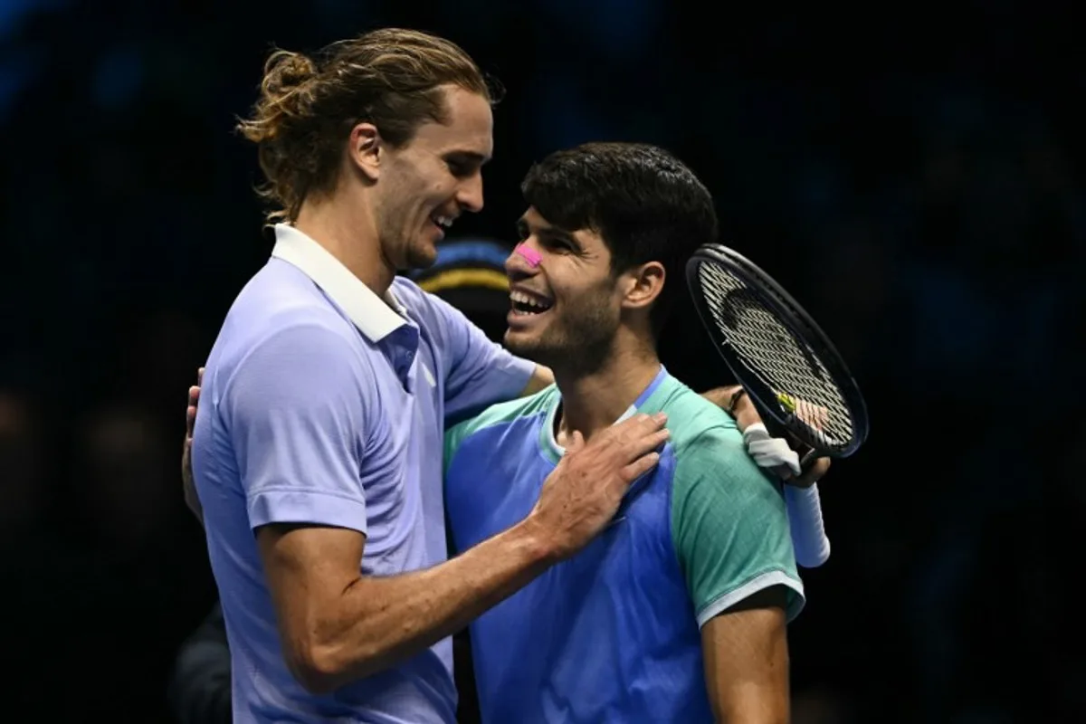 Germany's Alexander Zverev is congratulated by Spain's Carlos Alcaraz (R) after victory at the end of their match at the ATP Finals tennis tournament in Turin on November 15, 2024.  Marco BERTORELLO / AFP