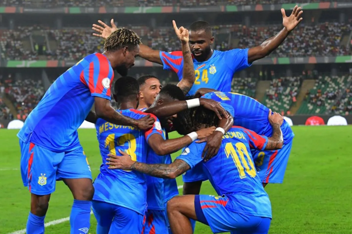 DR Congo's defender #22 Chancel Mbemba (C) celebrates with teammates after scoring his team's first goal during the Africa Cup of Nations (CAN) 2024 quarter-final football match between DR Congo and Guinea at the Alassane Ouattara Stadium in Ebimpe, Abidjan on February 2, 2024. SIA KAMBOU / AFP