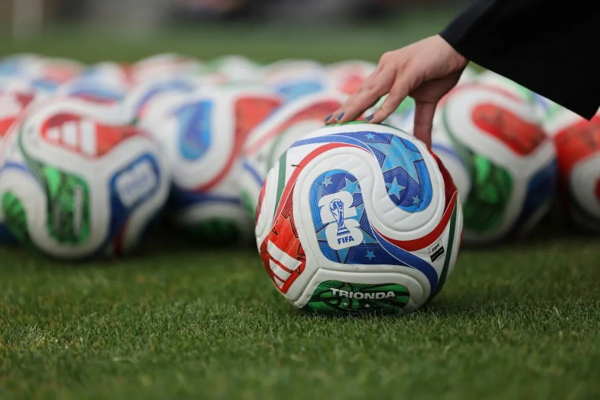 A woman holds a FIFA official World Cup 2026 ball during a training session of the Iranian national football team at their base camp in Antalya on May 19, 2026. Iran's national football team arrived in Turkey on May 19, 2026 for a training camp and to complete visa applications ahead of the 2026 World Cup, AFP correspondents said. Oner SAN / AFP