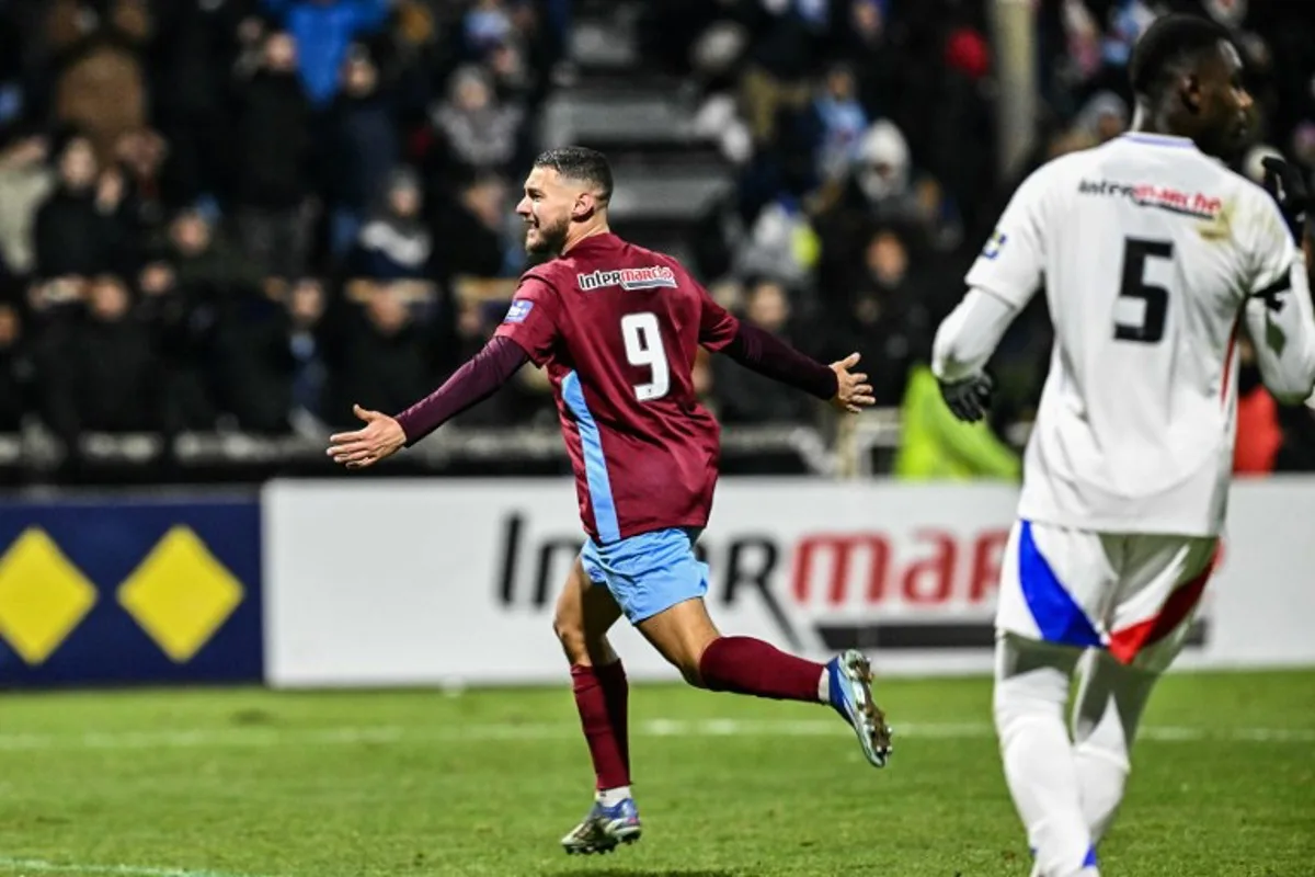 Bourgoin Jallieu's Moroccan midfielder #09 Mehdi Moujetsky (L) celebrates after scoring his team's second goal during the French Cup round of 32 football match between FC Bourgoin-Jallieu and Olympique Lyonnais (Lyon) at the Pierre-Rajon stadium in Bourgoin-Jallieu, central eastern France, on January 15, 2025.  JEFF PACHOUD / AFP