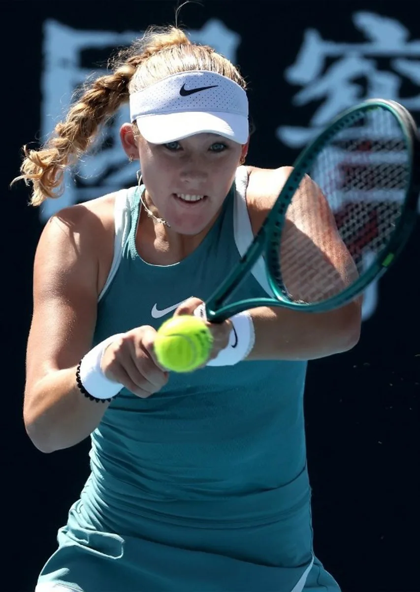 This handout picture released by the Tennis Australia on January 17, 2025 shows Russia's Mirra Andreeva hits a return against Poland's Magdalena Frech during their women's singles match at the Australian Open tennis tournament in Melbourne.   Hamish BLAIR / TENNIS AUSTRALIA / AFP