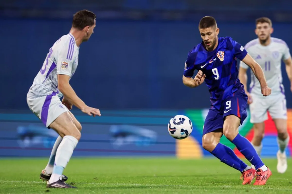 Croatia's forward #09 Andrej Kramaric (R) fights for the ball with Scotland's midfielder #23 Kenny McLean during the UEFA Nations League, League A Group A1 football match between Croatia and Scotland at the Maksimir Stadium in Zagreb on October 12, 2024.  DAMIR SENCAR / AFP