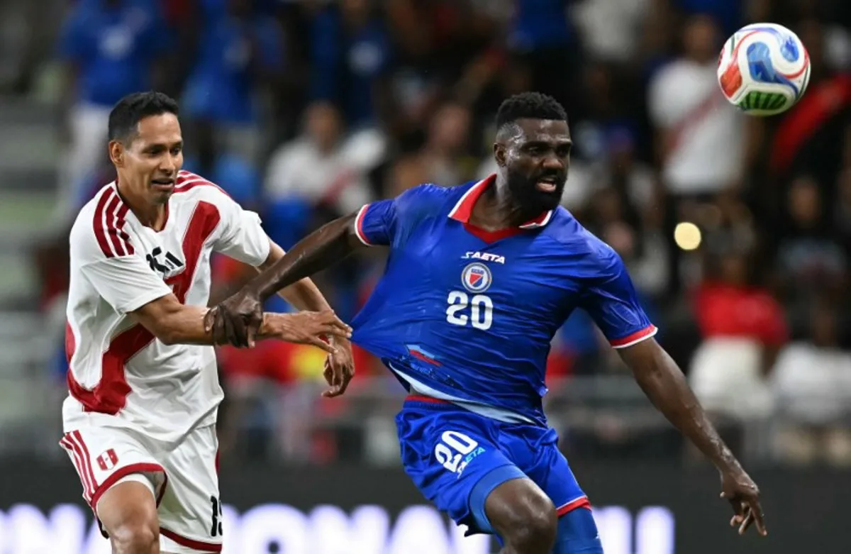 Haiti's forward #20 Frantzdy Pierrot and Peru's defender #15 Renzo Garces vie for the ball during the international friendly football match between Haiti and Peru at Nu Stadium in Miami, Florida on June 5, 2026. CHANDAN KHANNA / AFP