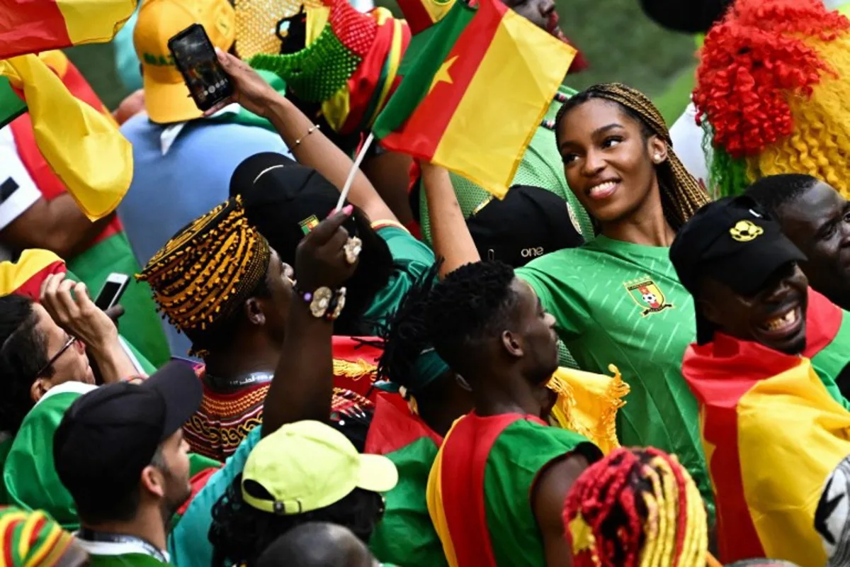 Cameroon's supporters cheer before the start of the Qatar 2022 World Cup Group G football match between Cameroon and Serbia at the Al-Janoub Stadium in Al-Wakrah, south of Doha on November 28, 2022. Anne-Christine POUJOULAT / AFP