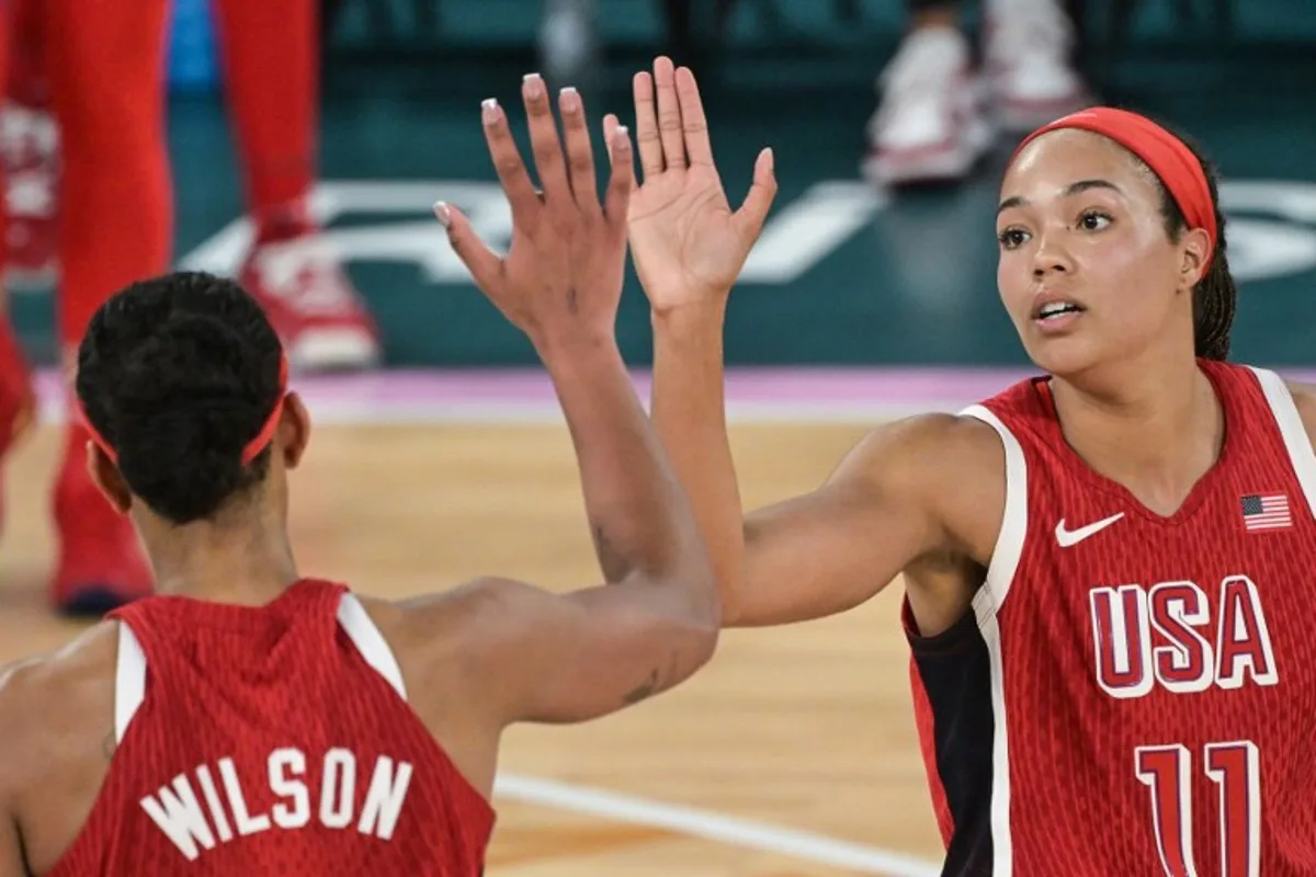 USA's #09 A'ja Wilson and USA's #11 Napheesa Collier celebrate in the women's Gold Medal basketball match between France and the USA during the Paris 2024 Olympic Games at the Bercy Arena in Paris on August 11, 2024. Damien MEYER / AFP
