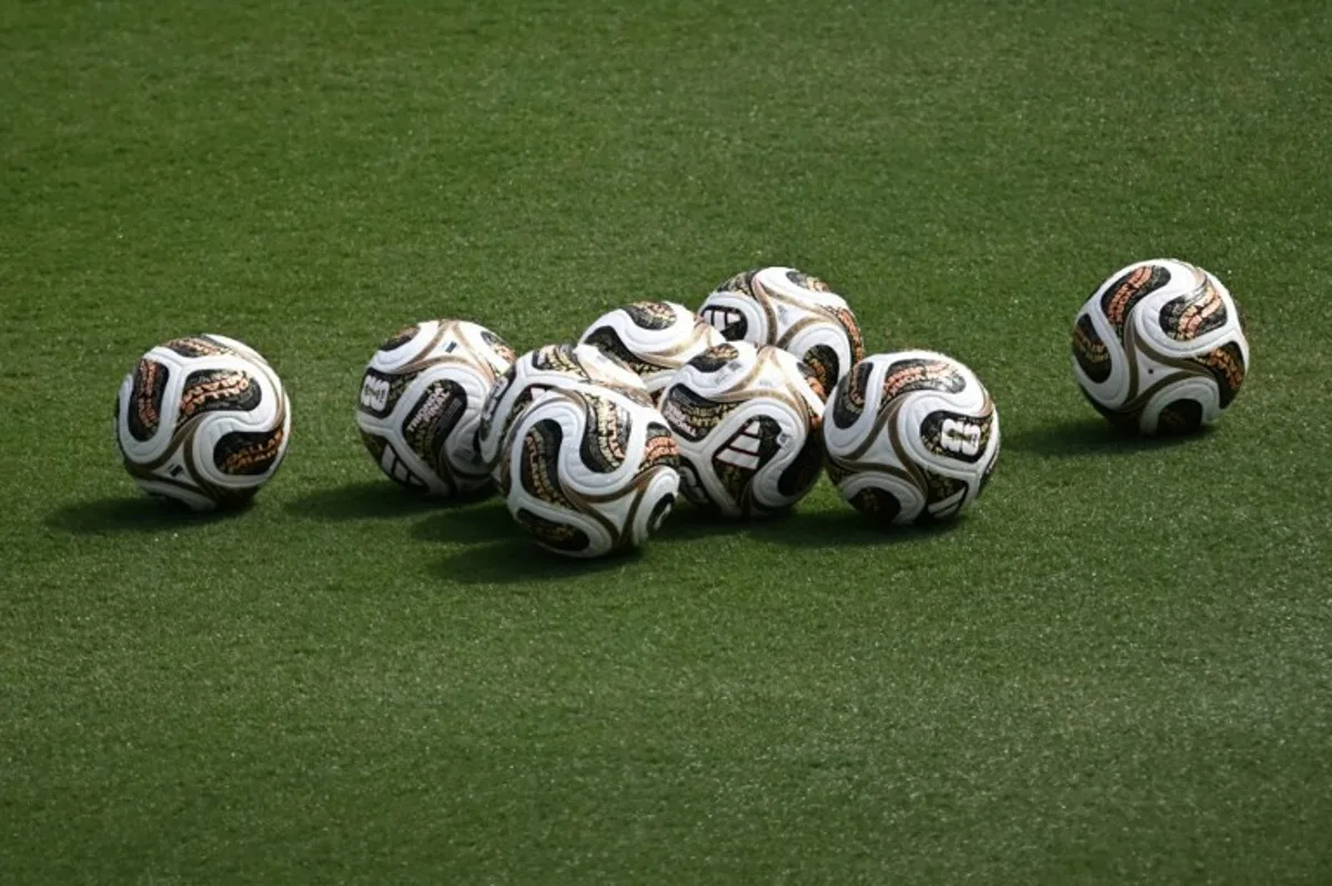 A photo the new official competition footballs for the semi-finals sitting in the pitch at a Spain training session at the at the Cotton Bowl Stadium in Dallas on July 12, 2026, during the 2026 World Cup foorball tournament.   Paul ELLIS / AFP
