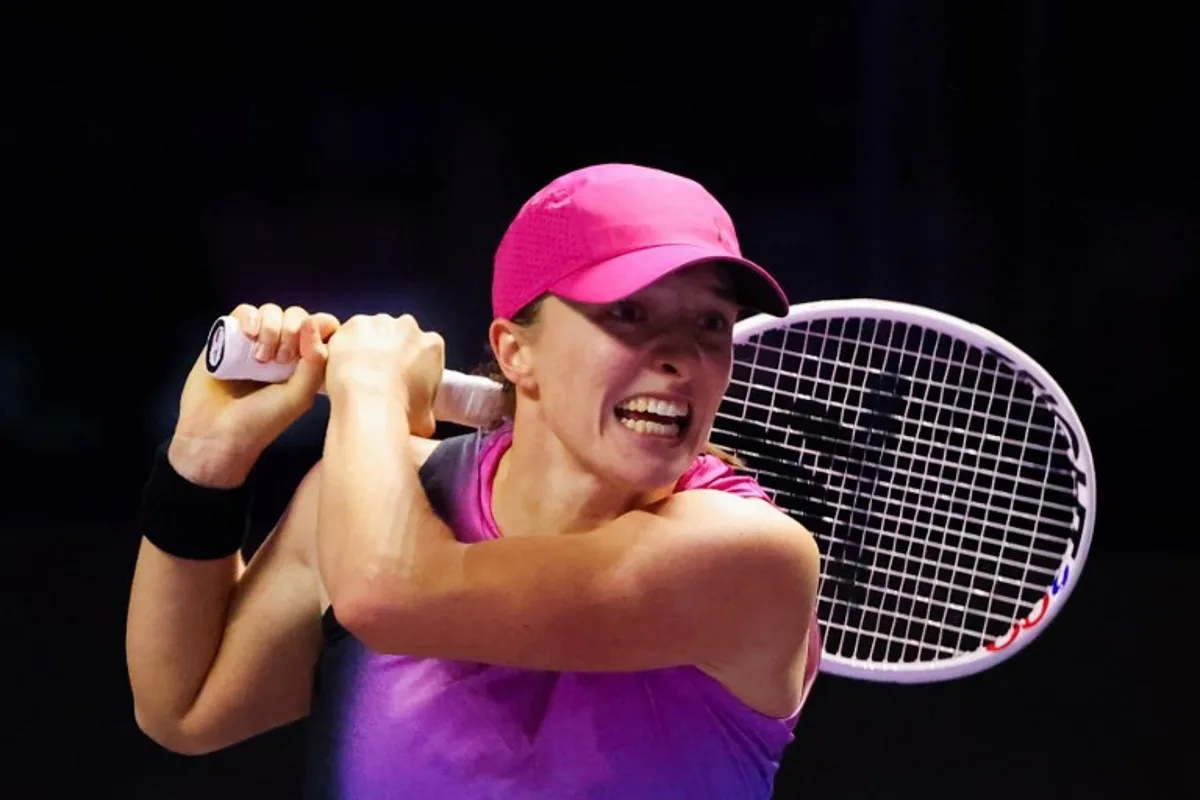 Poland's Iga Swiatek hits a return against Russia's Daria Kasatkina during their women's singles tennis match at the WTA Finals Championship in Riyadh on November 7, 2024.  Fayez NURELDINE / AFP