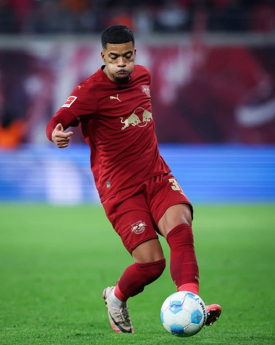 Leipzig's German defender #39 Benjamin Henrichs plays the ball during the German first division Bundesliga football match RB Leipzig v VfL Wolfsburg in Leipzig, eastern Germany on November 30, 2024.  Ronny Hartmann / AFP