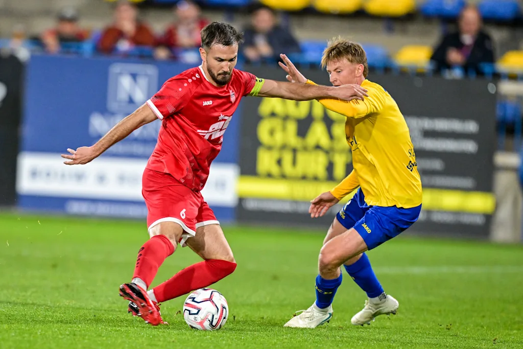 Habay's Hugo Vialette and Beveren's Ferre Slegers fight for the ball during a soccer match between SK Beveren and RSC Habay, Friday 16 October 2026 in Beveren, a game in the 1/16 final of the Croky Cup Belgian cup competition. BELGA PHOTO DAVID PINTENS