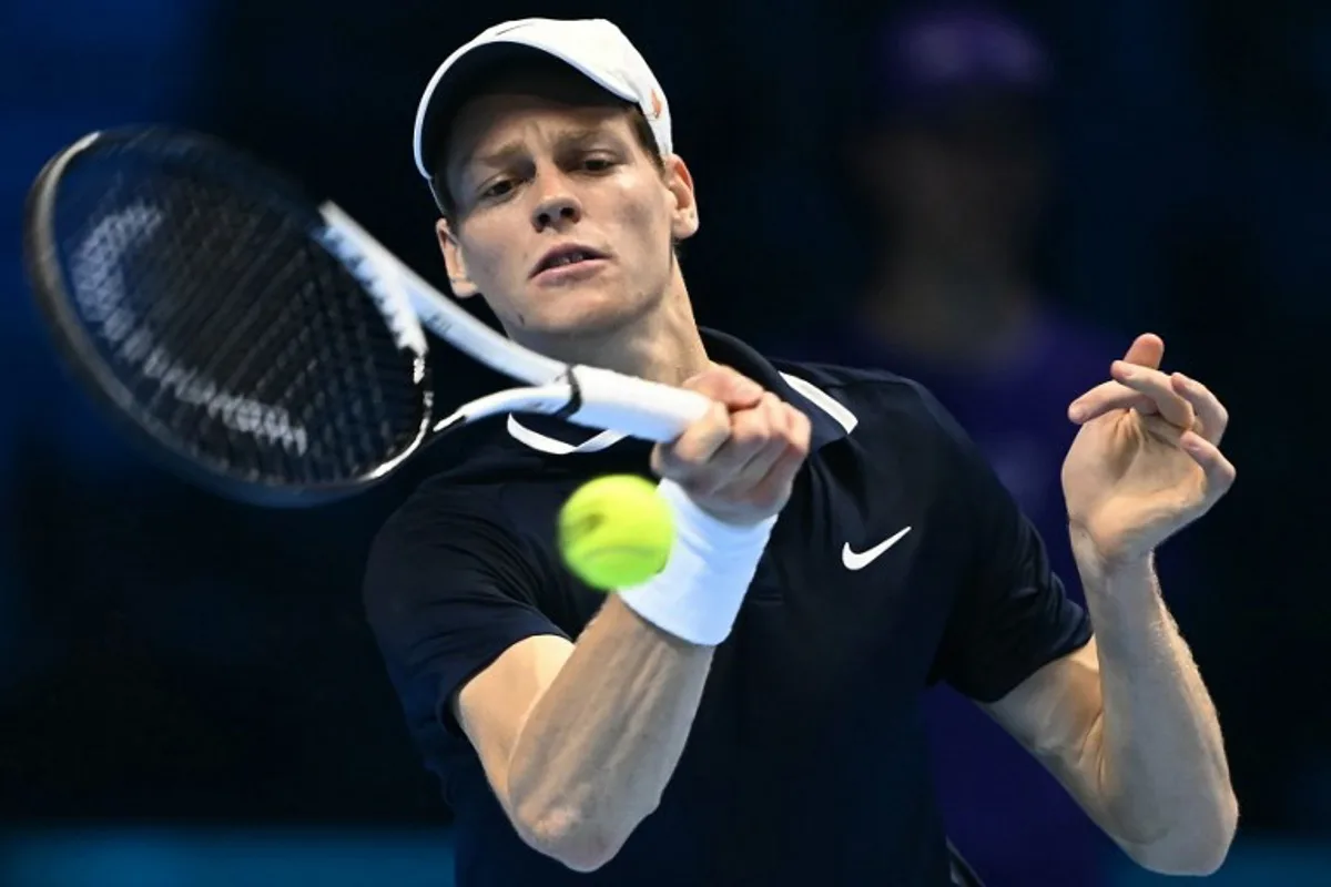 Italy's Jannik Sinner hits a return to Norway's Casper Ruud during their semi-final match at the ATP Finals tennis tournament in Turin on November 16, 2024.  Marco BERTORELLO / AFP