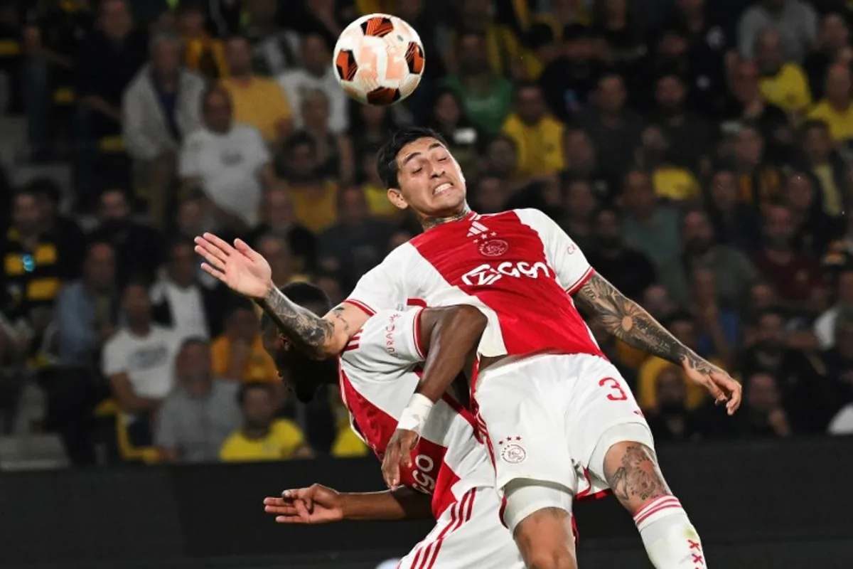 Ajax's Argentine defender #30 Gaston Avila (R) heads the ball next to Ajax's Dutch defender #04 Jorrel Hato during the UEFA Europa League 1st round day 2 Group B football match between AEK Athens and Ajax Amsterdam at the Agia Sophia Stadium in Athens on October 5, 2023.   Angelos Tzortzinis / AFP