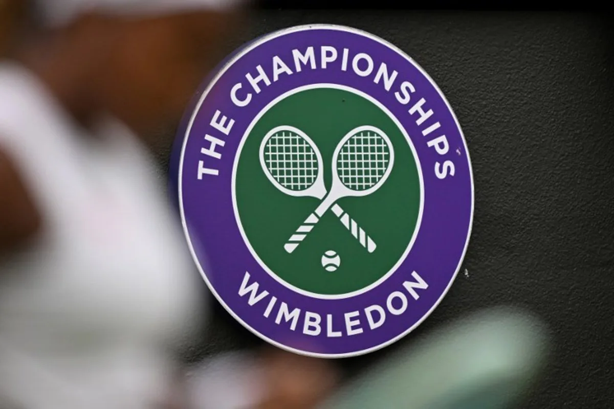 The Wimbledon logo is pictured behind US player Coco Gauff as she arranges the strings of her racket while playing against Romania's Anca Todoni during their women's singles second round tennis match on the third day of the 2024 Wimbledon Championships at The All England Lawn Tennis and Croquet Club in Wimbledon, southwest London, on July 3, 2024. ANDREJ ISAKOVIC / AFP