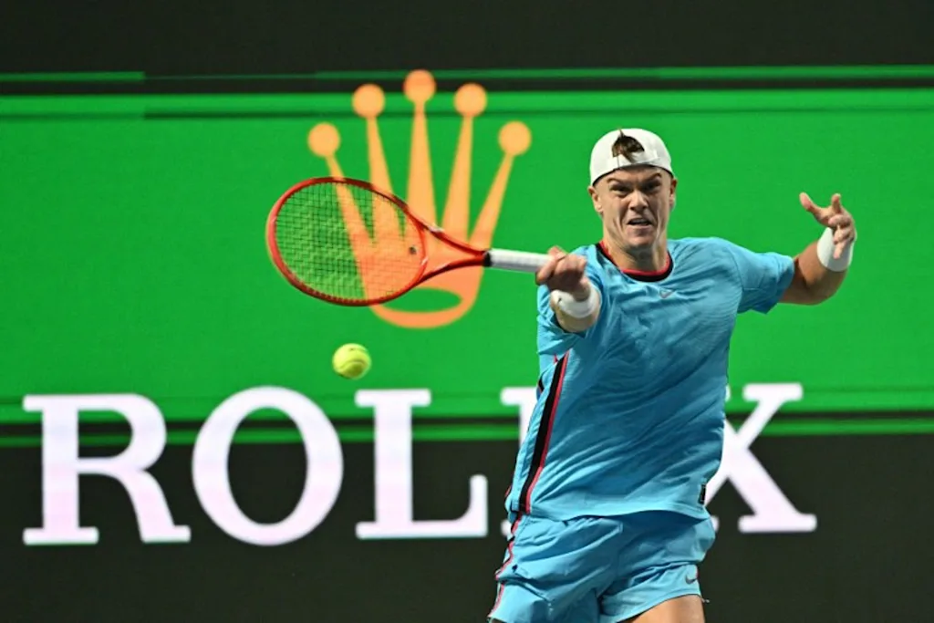 Denmark's Holger Rune hits a return to Germany's Daniel Altmaier during their men's singles match at the Shanghai Masters tennis tournament in Shanghai on October 7, 2026. Hector RETAMAL / AFP