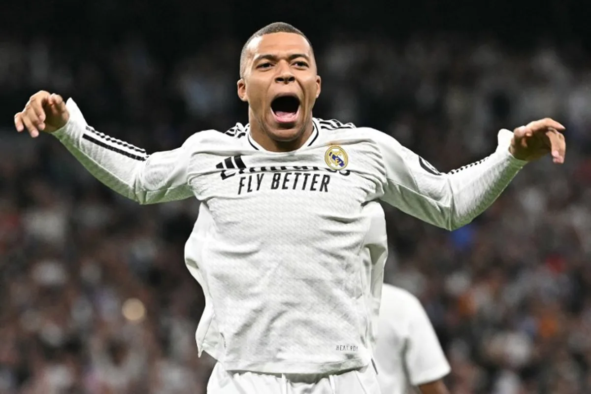 Real Madrid's French forward #09 Kylian Mbappe celebrates scoring the opening goal during the UEFA Champions League knockout phase play-off football match between Real Madrid CF and Manchester City at the Santiago Bernabeu stadium in Madrid on February 19, 2025.  JAVIER SORIANO / AFP