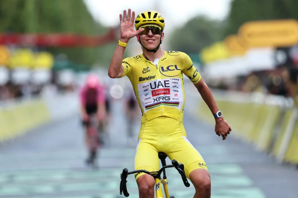UAE Team Emirates - XRG's Slovenian rider Tadej Pogacar celebrates his overall victory as he crosses the finish line of the 21st stage of the 113th edition of the Tour de France cycling race, 88,7 km starting and finishing in Paris, on July 26, 2026. Anne-Christine POUJOULAT / AFP