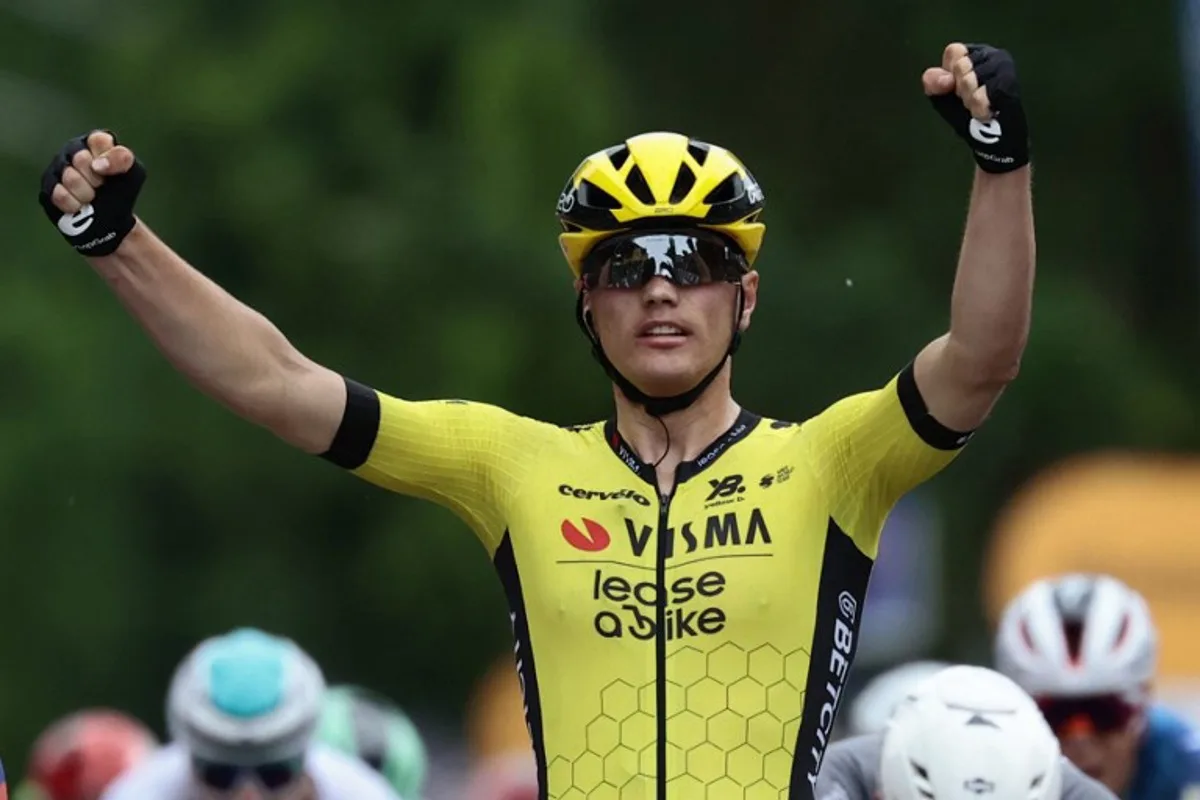 Team Visma-Lease a Bike's Dutch rider Olav Kooij celebrates after victory as he crosses the finish of the 12th stage of the 108th Giro d'Italia cycling race 172kms from Modena to Viadana on May 22, 2025. Luca Bettini / AFP