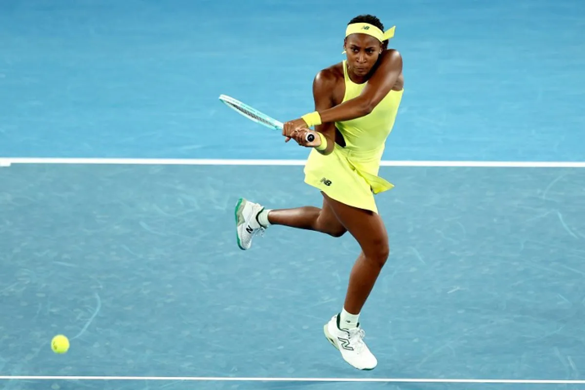 USA's Coco Gauff hits a return against Britain's Jodie Burrage during their women's singles match on day four of the Australian Open tennis tournament in Melbourne on January 15, 2025.  Martin KEEP / AFP