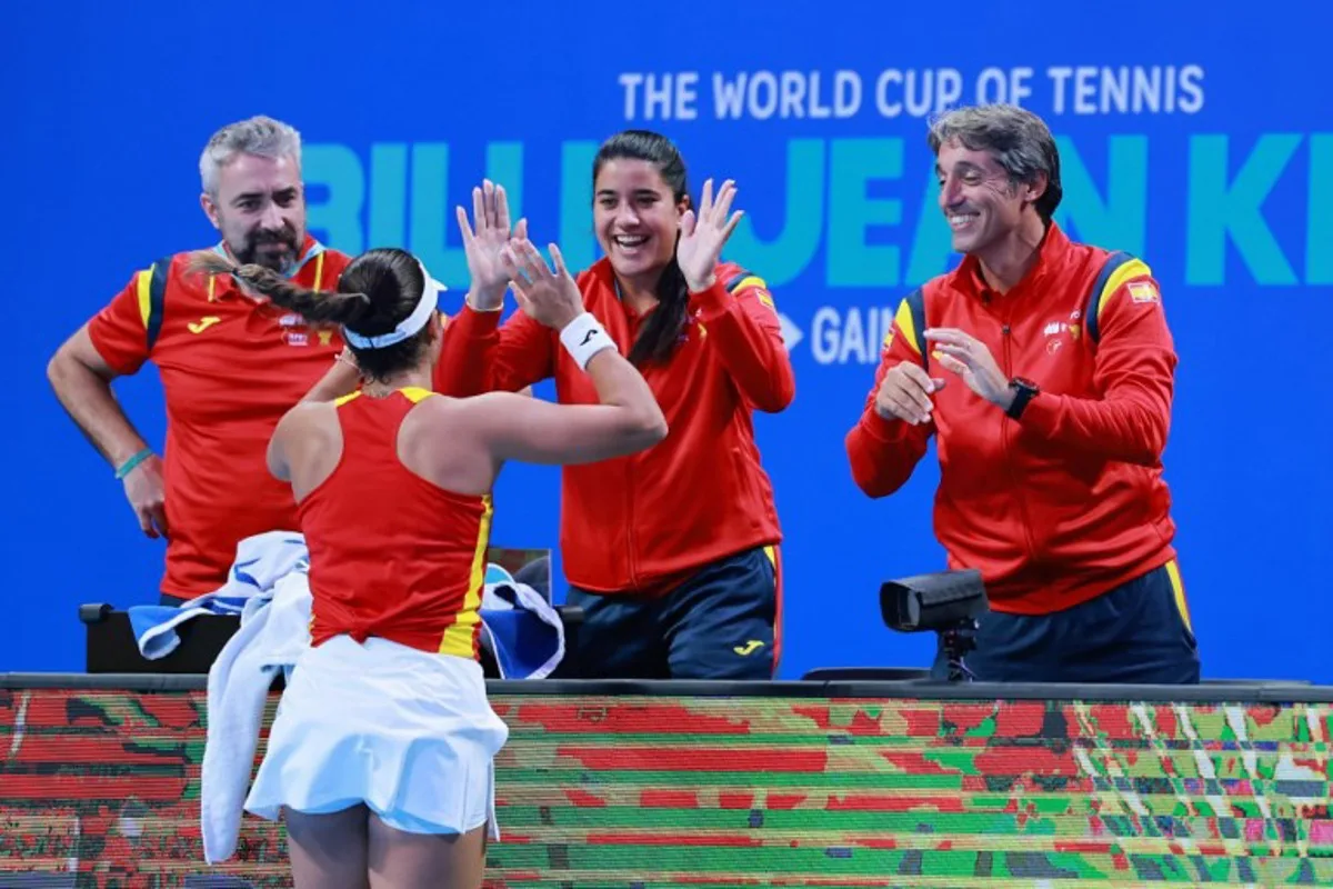 Spain's Jessica Bouzas Maneiro reacts with team members after beating Kazakhstan's Sonja Zhiyenbayeva in their women's singles quarter-final match at the Billie Jean King Cup tennis tournament in Shenzhen, in China's southern Guangdong province on September 23, 2026. CN-STR / AFP