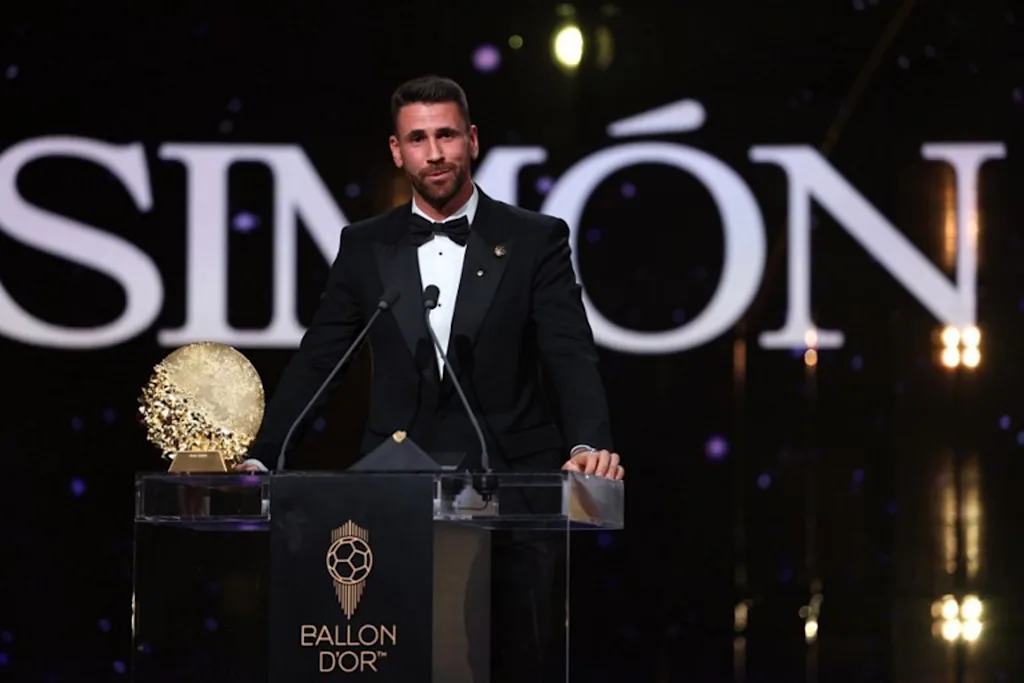 Spain's goalkeeper Unai Simon speaks after receiving the Yashin Trophy for the best male goalkeeper during the 2026 Ballon d'Or France Football award ceremony at the Palladium Theatre in London on October 26, 2026.  FRANCK FIFE / AFP