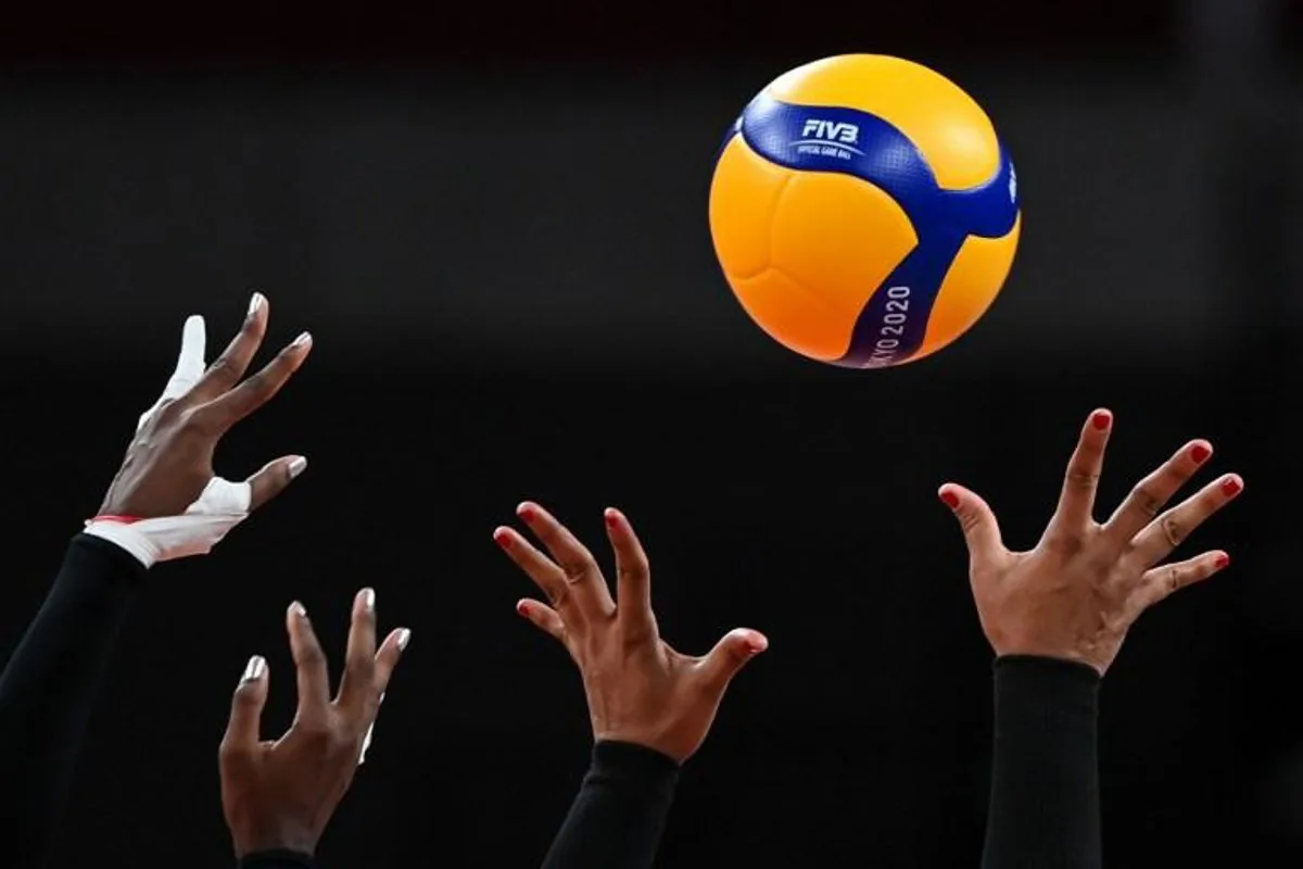 This picture shows the hands of Dominican Republic's Brayelin Martinez (L) and Prisilla Rivera Brens as they try to block a shot in the women's quarter-final volleyball match between USA and Dominican Republic during the Tokyo 2020 Olympic Games at Ariake Arena in Tokyo on August 4, 2021.  YURI CORTEZ / AFP