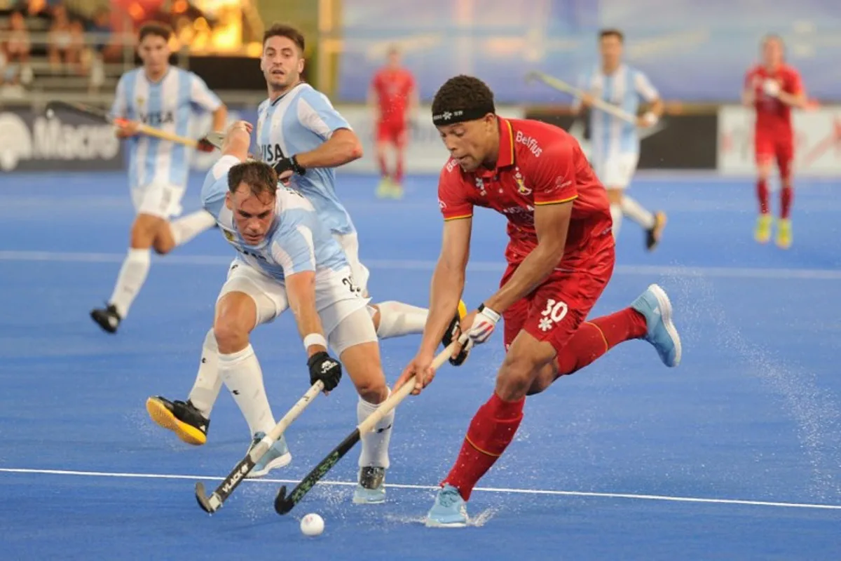 Belgium's #30 Nelson Onana (R) and Argentina's #29 Thomas Habif fight for the ball during their FIH Pro League hockey match in Santiago del Estero, Argentina on February 19, 2025.  Eduardo RAPETTI / AFP