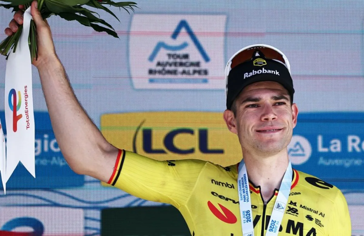Stage winner Team Visma | Lease a Bike's Belgian rider Wout Van Aert celebrates on the podium of the 5th stage of the Tour Auvergne-Rhone-Alpes cycling race (formerly known as the Criterium du Dauphine), 195,8km between Saint-Chamond and Villars-les-Dombes, central France, on June 11, 2026. Anne-Christine POUJOULAT / AFP