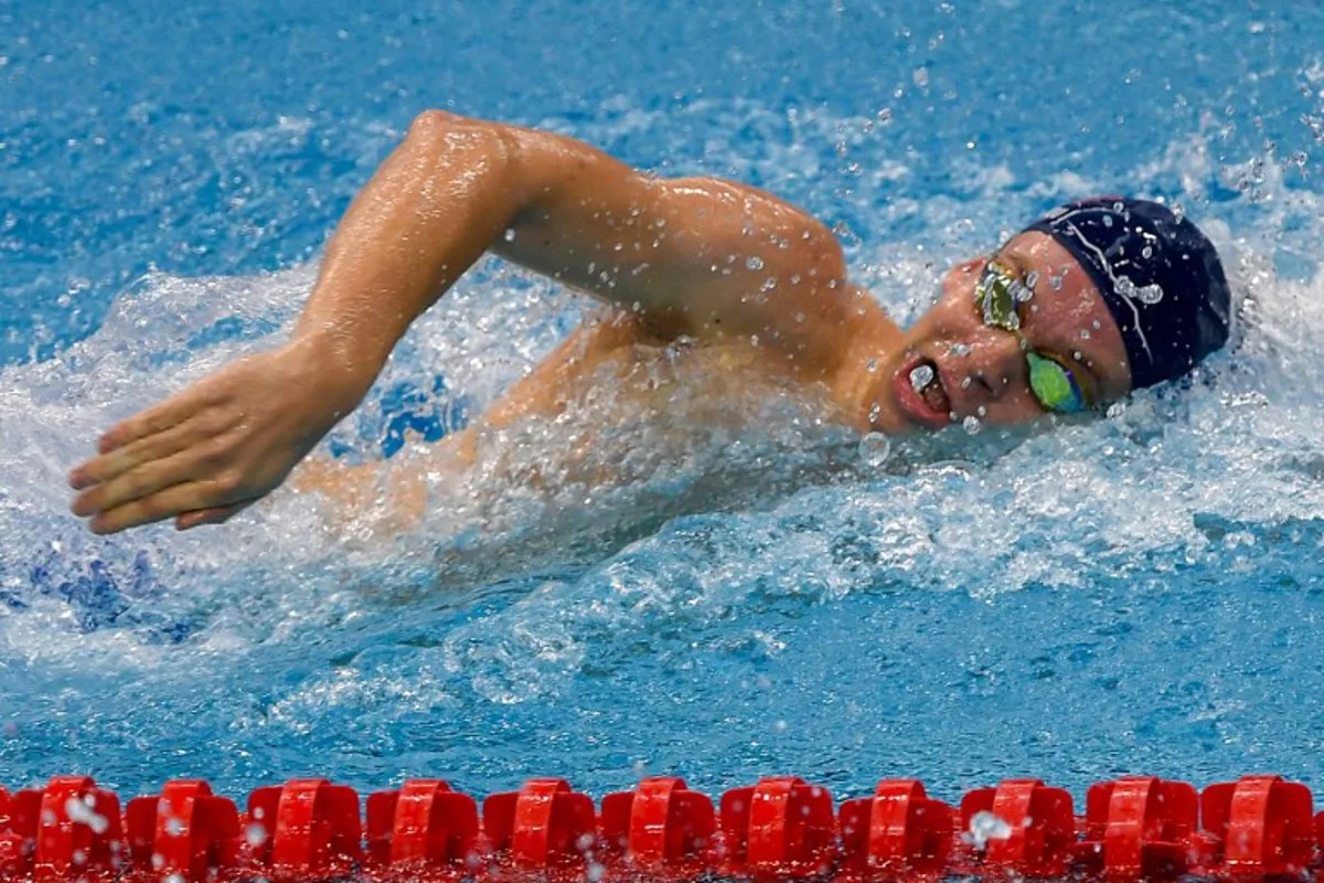 (FILES) France's Leon Marchand competes in the men's 200m freestyle heat event during the World Aquatics Swimming World Cup 2024 - Stop 3 in Singapore on November 2, 2024. Four-time Olympic swimming champion Leon Marchand, the star of the Paris Games, announced on November 30, 2024 that he would be withdrawing from the World Aquatics Swimming Championships (25m), to be held in Budapest from December 10 to 15, saying he was 'exhausted'. Roslan RAHMAN / AFP