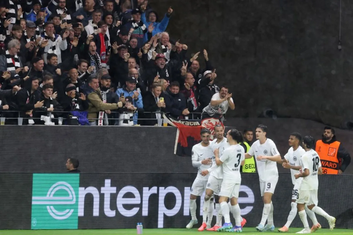 Frankfurt's players celebrate after Frankfurt's French forward #11 Hugo Ekitike scored the team's first goal during the UEFA Europa League football match between Eintracht Frankfurt and Viktoria Plzen in Frankfurt am Main, western Germany on September 26, 2024.  Daniel ROLAND / AFP