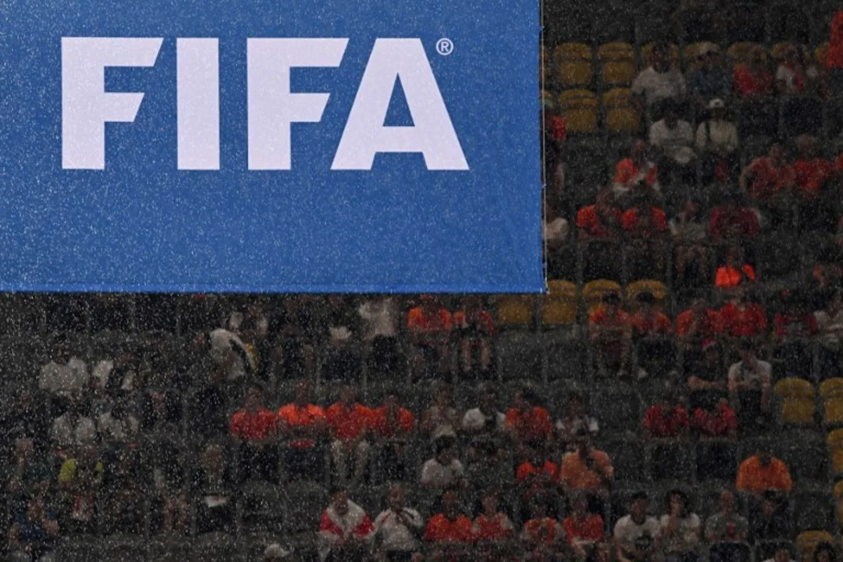 Rain falls in front of a FIFA logo before the start of the UEFA Euro 2024 semi-final football match between the Netherlands and England at the BVB Stadion in Dortmund on July 10, 2024. Kirill KUDRYAVTSEV / AFP