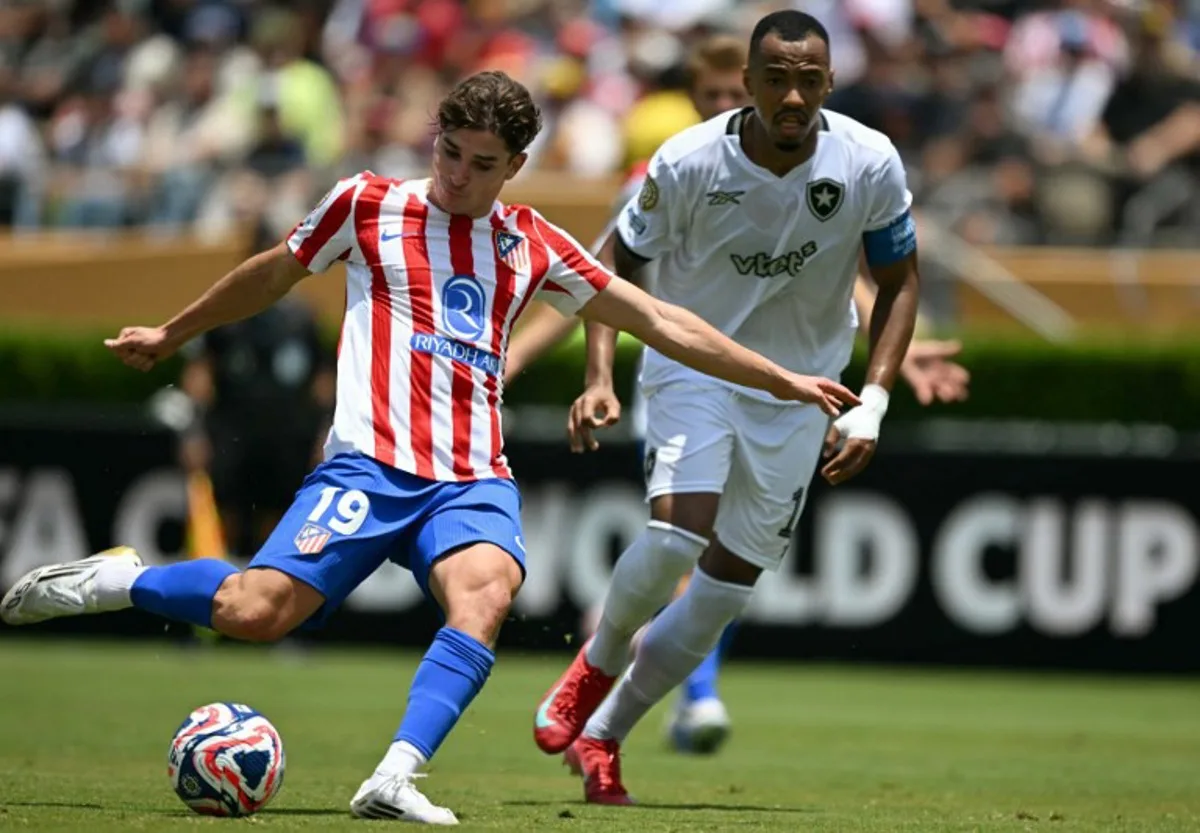 Atletico Madrid's Argentine forward #19 Julian Alvarez and Botafogo's Brazilian midfielder #17 Marlon Freitas fight for the ball during the FIFA Club World Cup 2025 Group B football match between Spain's Atletico de Madrid and Brazil's Botafogo at the Rose Bowl stadium in Los Angeles on June 23, 2025. YURI CORTEZ / AFP