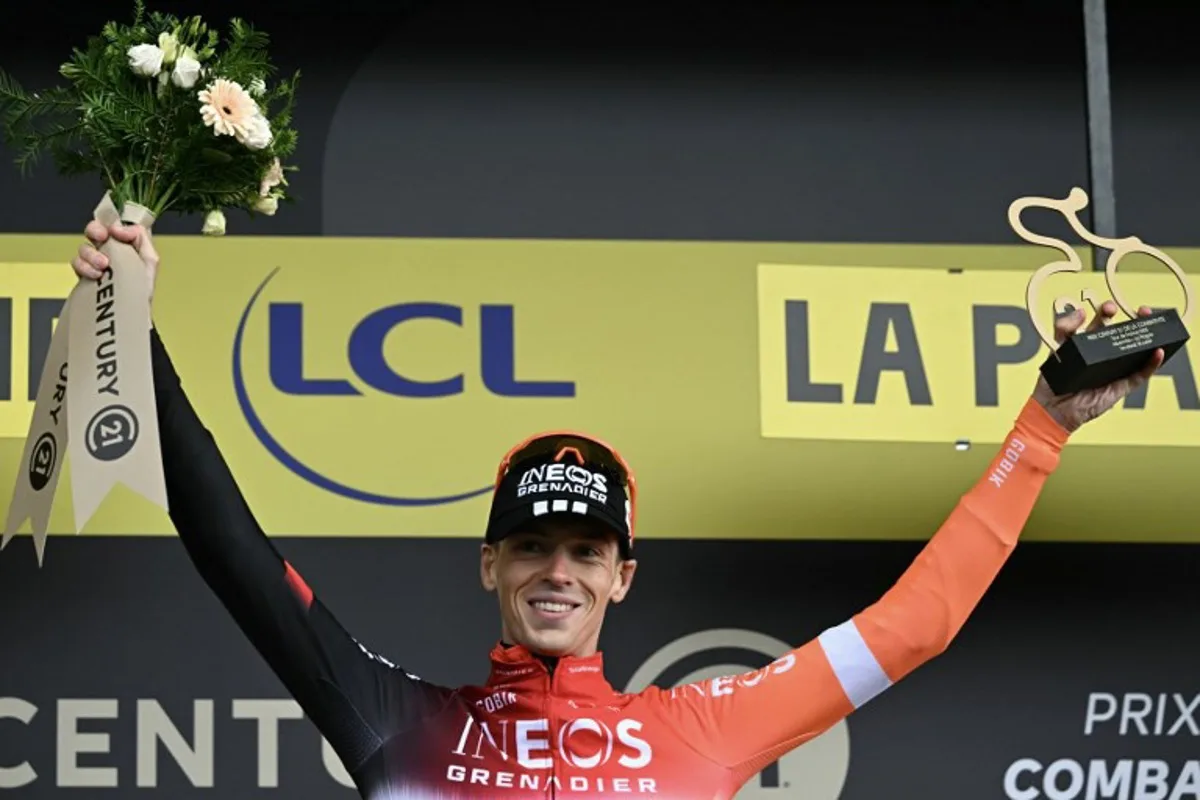 INEOS Grenadiers team's Dutch rider Thymen Arensman celebrates on the podium with the most combative rider's award after the 19th stage of the 112th edition of the Tour de France cycling race, 93.1 km between Albertville and La Plagne, in the French Alps, on July 25, 2025. The 19th stage of the Tour de France was shorted from its initial 129.9 km route, bypassing the Col des Saisies where an outbreak of nodular dermatitis in a herd of cattle was discovered, prompting organizers to modify the race route. Loic VENANCE / AFP