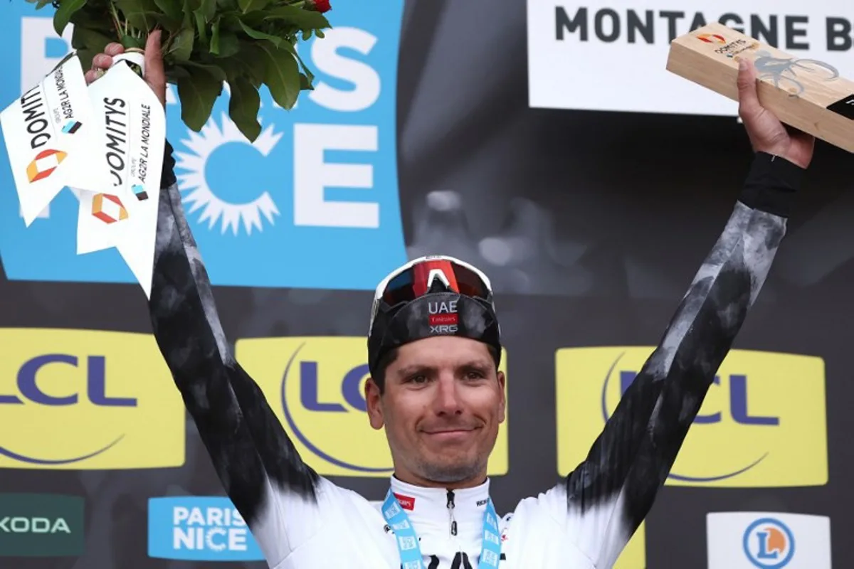 UAE Team Emirates XRG's Portuguese rider Joao Almeida celebrates on the podium after winning the 4th stage of the Paris-Nice cycling race, 163,4 km between Vichy and La Loge des Gardes, on March 12, 2025. Anne-Christine POUJOULAT / AFP