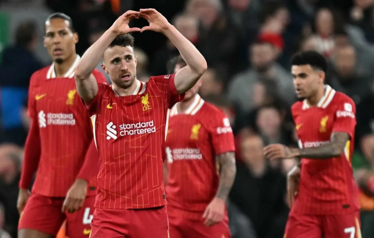 Liverpool's Portuguese striker #20 Diogo Jota (2L) celebrates scoring the opening goal during the English Premier League football match between Liverpool and Everton at Anfield in Liverpool, north west England on April 2, 2025. Paul ELLIS / AFP