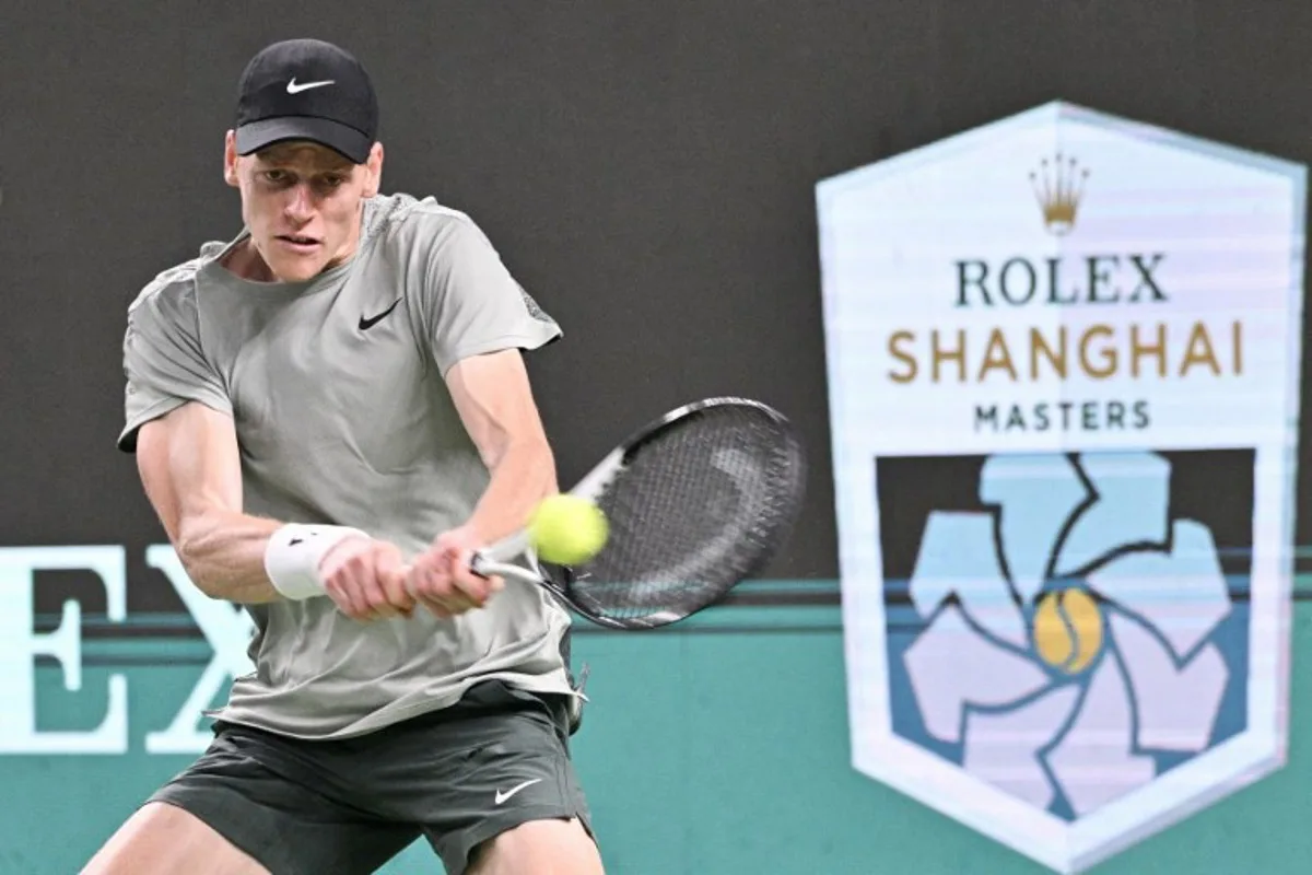 Italy's Jannik Sinner hits a return to Argentina's Tomas Martin Etcheverry during their men's singles match at the Shanghai Masters tennis tournament in Shanghai on October 6, 2024.  HECTOR RETAMAL / AFP