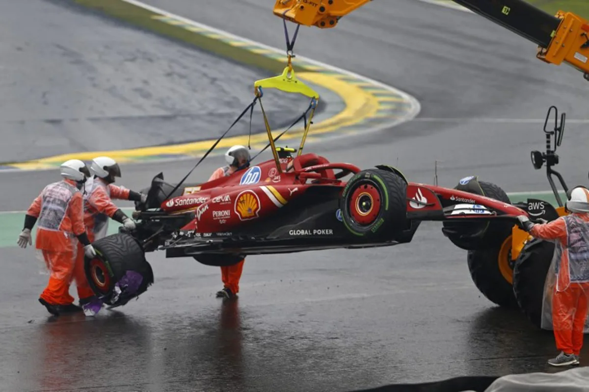 The car of Ferrari's Spanish driver Carlos Sainz is removed from the track after an accident during the qualifying session for the Formula One Sao Paulo Grand Prix, at the Jose Carlos Pace racetrack, aka Interlagos, in Sao Paulo, Brazil, on November 3, 2024.  Miguel Schincariol / AFP