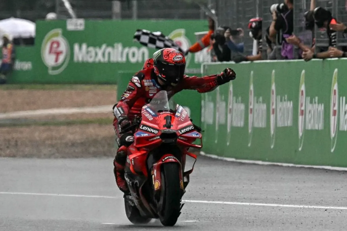 Ducati Lenovo Team's Italian rider Francesco Bagnaia celebrates winning the MotoGP Thailand Grand Prix at the Buriram International Circuit in Buriram on October 27, 2024.  Lillian SUWANRUMPHA / AFP