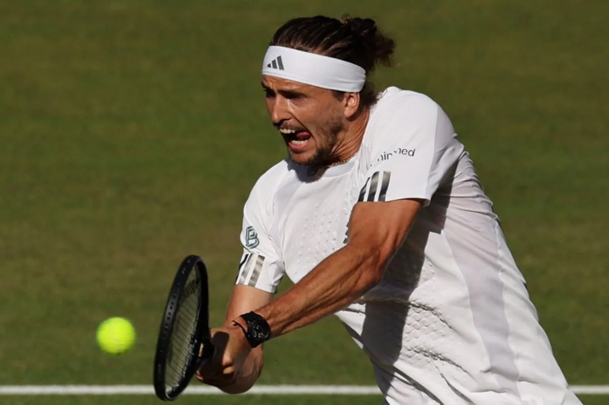 Germany's Alexander Zverev returns to Italy's Jannik Sinner during their men's singles final tennis match on the fourteenth day of the 2026 Wimbledon Championships at The All England Lawn Tennis and Croquet Club in Wimbledon, southwest London, on July 12, 2026. Adrian Dennis / AFP