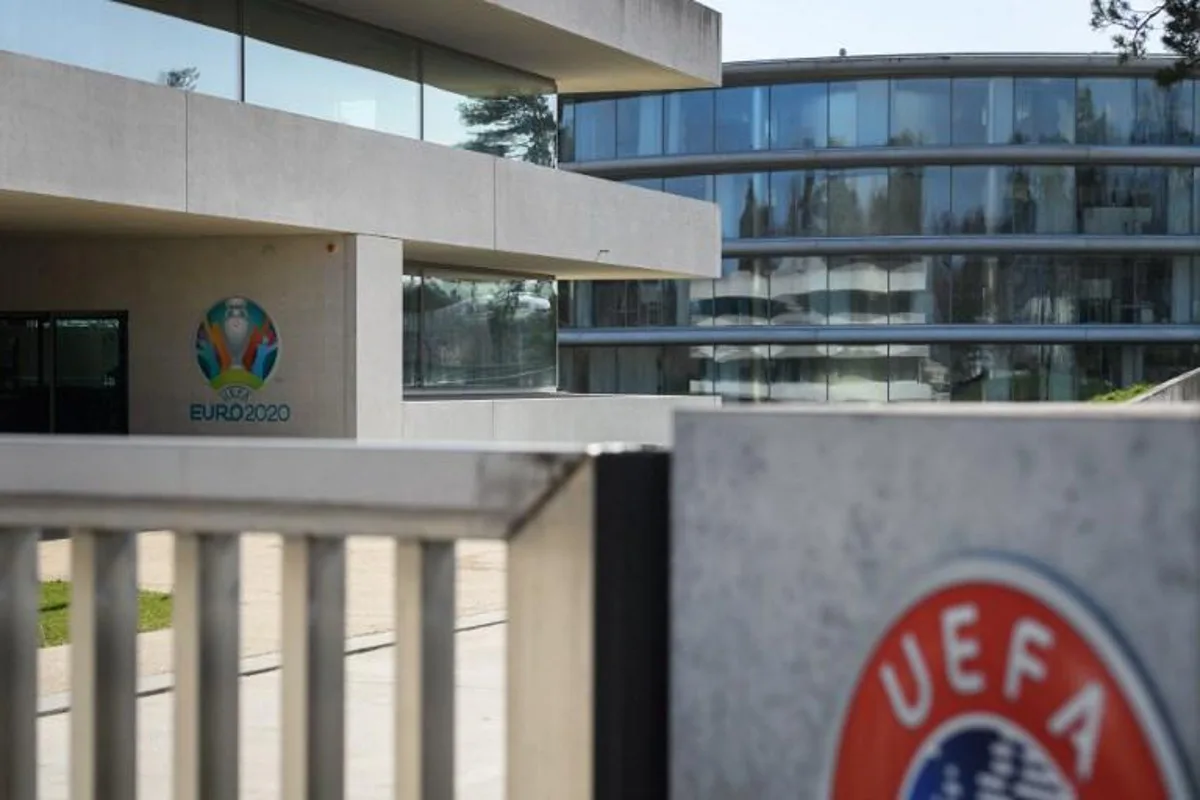 This photograph taken in Nyon on March 17, 2020, shows the Euro 2020 logo at the headquarters of UEFA, the European football's governing body, amid spread of novel coronavirus, COVID-19. UEFA has proposed postponing the European Championship, due to take place across the continent in June and July this year, until 2021 at crisis meetings on Tuesday, a source close to European football's governing body told AFP. Fabrice COFFRINI / AFP