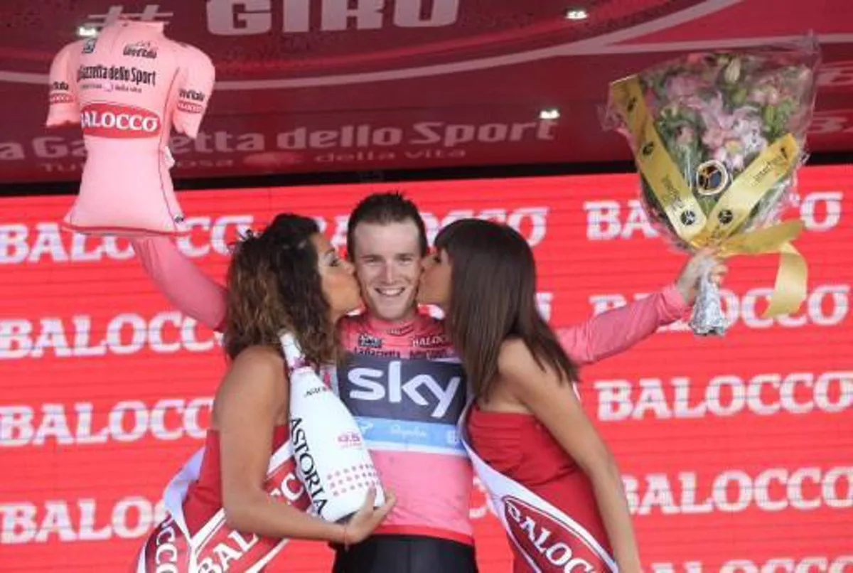 Italian Salvatore Puccio celebrates on the podium gaining the pink jersey on the podium of the second stage of 96th Giro d'Italia Team Time Trial, a 17.4 km from Ischia to Forio on May 5, 2013 in Forio, on the island of Ischia. Italian Salvatore Puccio of Team Sky took possession of the Giro d'Italia pink jersey from overnight leader Mark Cavendish on Sunday after Team Sky dominated a stage two team time trial on the island of Ischia. AFP PHOTO / LUK BENIES