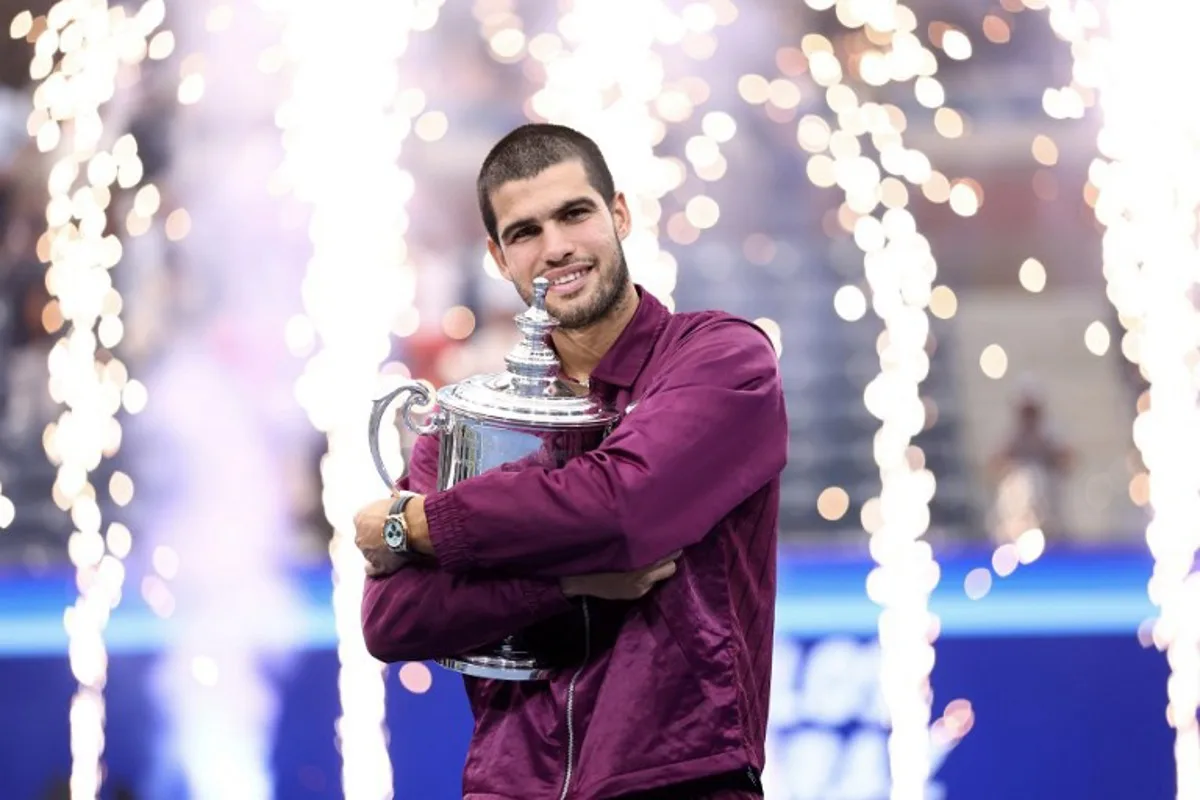 Spain's Carlos Alcaraz celebrates with his trophy winning over Italy's Jannik Sinner during their men's singles final tennis match on day fifteen of the US Open tennis tournament at the USTA Billie Jean King National Tennis Center in New York City, on September 7, 2025. CHARLY TRIBALLEAU / AFP