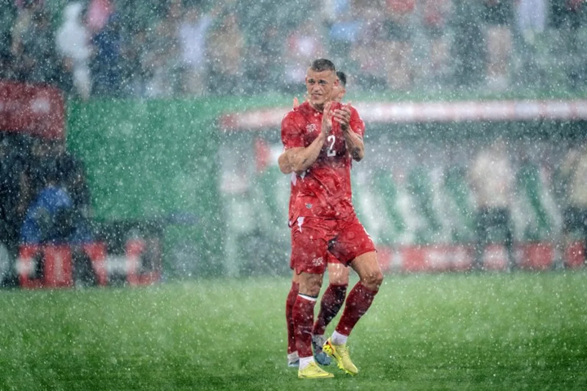 Switzerland's defender #2 Miro Muheim waves goodbye in the rain at the end of a friendly football match between Switzerland and Jordan ahead of the 2026 FIFA World Cup tournament at the Kybunpark in St. Gallen on May 31, 2026. Ennio LEANZA / AFP
