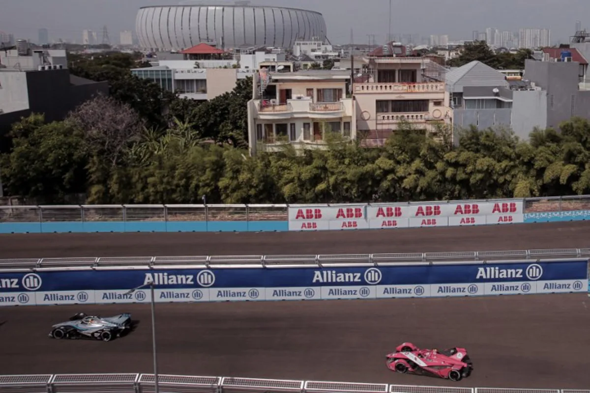 Mercedes EQ Formule E Team driver Belgian Stoffel Vandoorne (L) and Avalanche Andretti Formula E driver British Jake Dennis (R) compete in the Formula E qualifying session at the Jakarta Formula E circuit in Jakarta on June 4, 2022. POPOH RIA / AFP