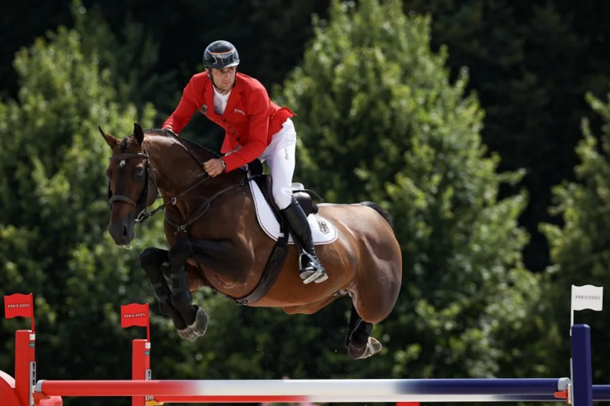 Germany's Richard Vogel with horse United Touch S competes in the equestrian's jumping team final during the Paris 2024 Olympic Games at the Chateau de Versailles, in Versailles, in the western outskirts of Paris, on August 2, 2024.  Pierre-Philippe MARCOU / AFP