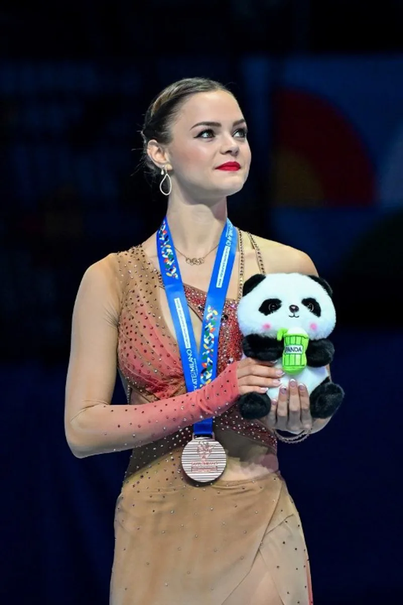Bronze medallist Belgium's Loena Hendrickx attends an awards ceremony for women's free skating during the ISU Skate to Milano Figure Skating Qualifier 2025 in Beijing on September 20, 2025.  ADEK BERRY / AFP