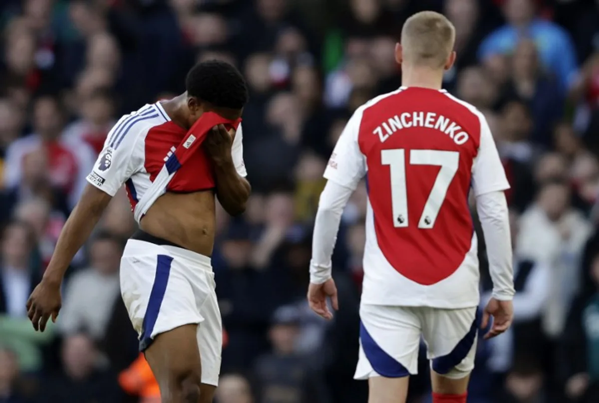 Arsenal's English midfielder #49 Myles Lewis-Skelly (L) reacts after having been shown a red card during the English Premier League football match between Arsenal and West Ham United at the Emirates Stadium in London on February 22, 2025.   Ian Kington / IKIMAGES / AFP