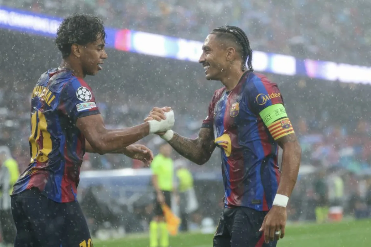 Barcelona's Brazilian forward #11 Raphinha (R) celebrates scoring his team's first goal with teammate Barcelona's Spanish forward #10 Lamine Yamal during the UEFA Champions League first round day 1 football match between FC Barcelona and Feyenoord at Camp Nou stadium in Barcelona on September 9, 2026. Lluis GENE / AFP